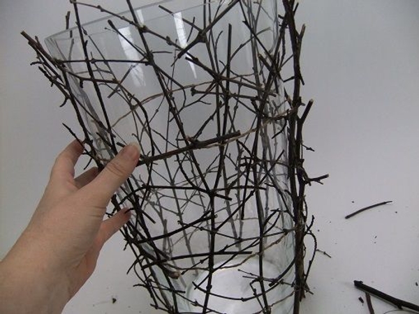 Wiggle the twigs to make sure you glue the twigs to other twigs and not to the glass vase Wiggle the twigs to make sure you glue the twigs to other twigs and not to the glass vase
