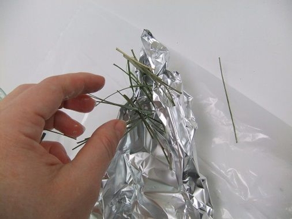Scatter the glue soaked strands over the foil shape Scatter the glue soaked strands over the foil shape