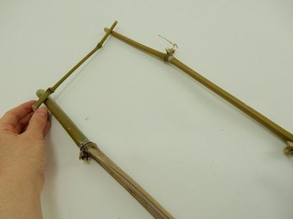 Lay two bamboo pieces on a working surface and place a thinner piece across the top Lay two bamboo pieces on a working surface and place a thinner piece across the top
