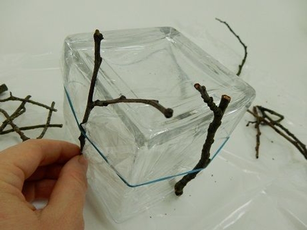 These twigs should extend slightly over the vase bottom. These twigs should extend slightly over the vase bottom.