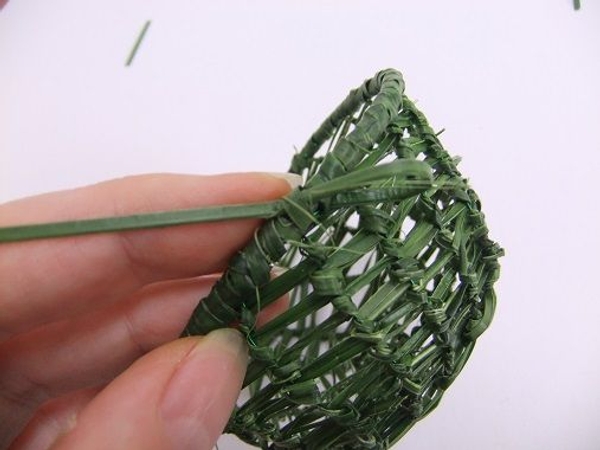 Knot the strand of grass on itself and cut away any loose pieces Knot the strand of grass on itself and cut away any loose pieces