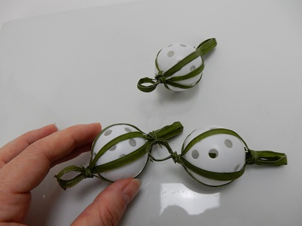 Slip the grass bauble lanterns from the dowel