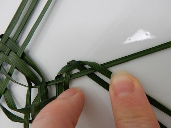 Fold the next blade over to create a downward pattern. Fold the next blade over to create a downward pattern.