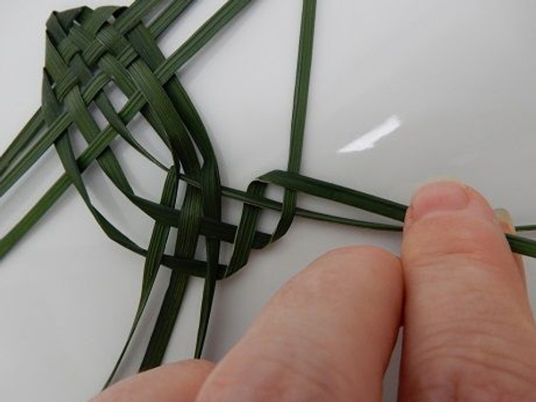 Fold the top blade over the next blade. Fold the top blade over the next blade.