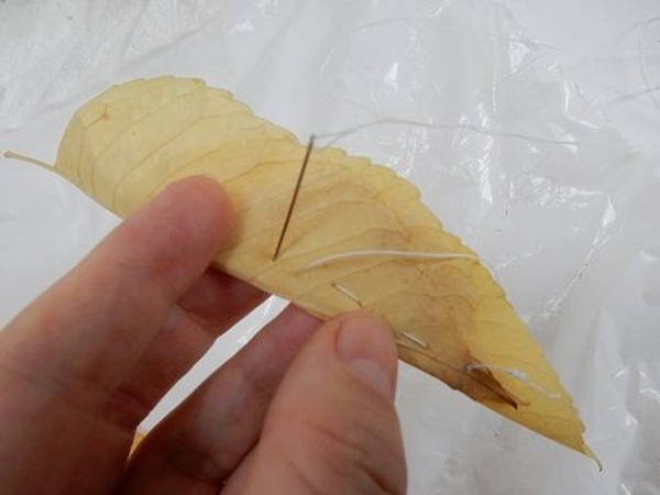 Fold the leaves over and stitch together Fold the leaves over and stitch together