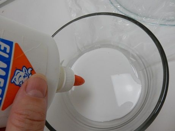 Pour out wood glue into a bowl Pour out wood glue into a bowl