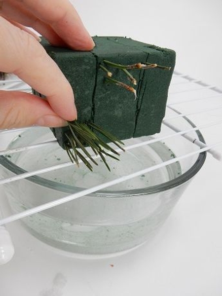 Start pressing the pine needles into the foam Start pressing the pine needles into the foam