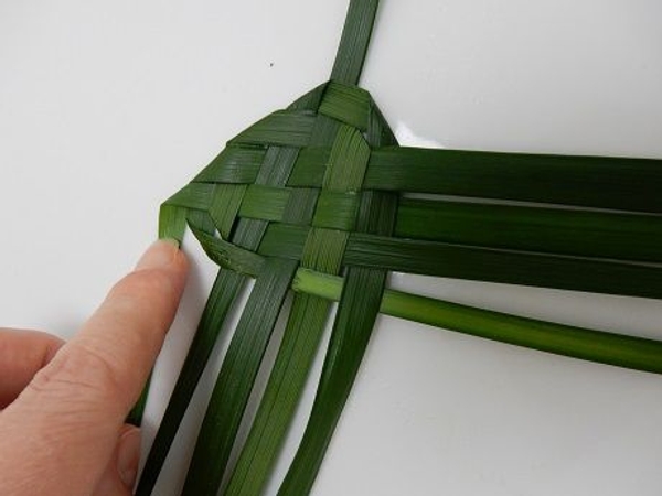 Fold the last top leaf on the left under Fold the last top leaf on the left under