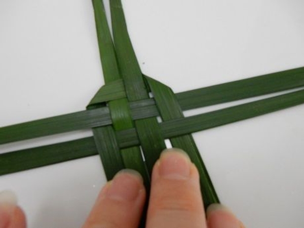 Fold the leaf down over and under the horizontal leaves Fold the leaf down over and under the horizontal leaves