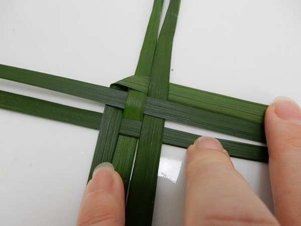 Fold the outer left leaf over and under the right leaves Fold the outer left leaf over and under the right leaves
