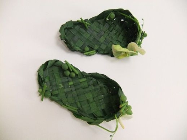 Weaving foliage to make slippers Weaving foliage to make slippers