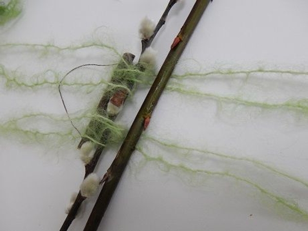 Fold the string open and add a twig Fold the string open and add a twig