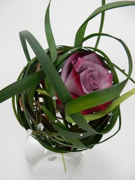 Genly twirl the grass around the rose to cup it Genly twirl the grass around the rose to cup it
