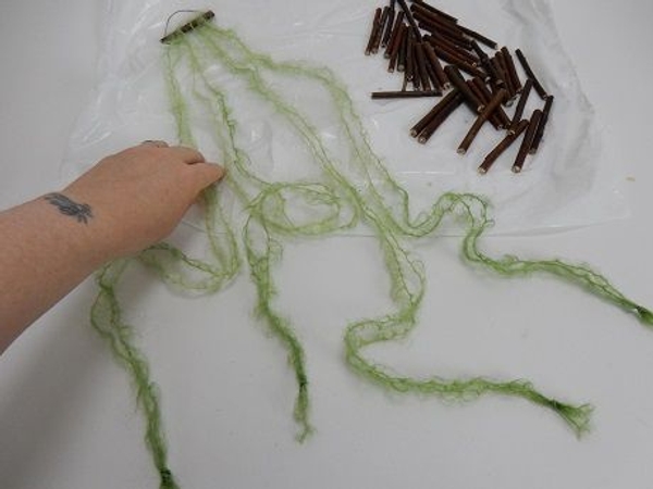 Place the string on a flat working surface Place the string on a flat working surface