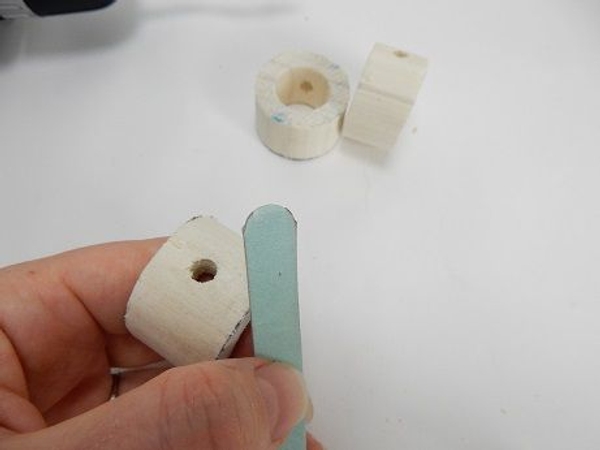Sand down the slice with an emery board or fine sanding paper Sand down the slice with an emery board or fine sanding paper