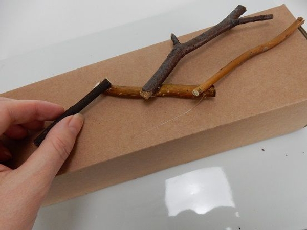 Follow the box shape and glue twig after twig. Follow the box shape and glue twig after twig.