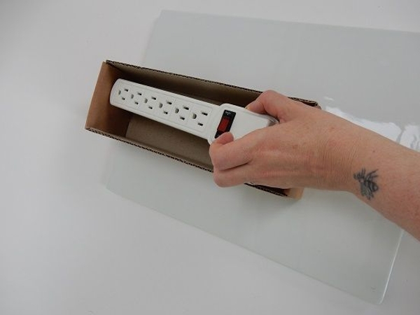 Measure the box by placing the power strip into the box. Measure the box by placing the power strip into the box.