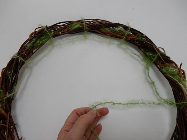 Move around the wreath creating wool loops Move around the wreath creating wool loops