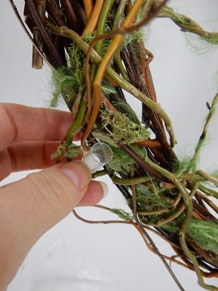 Place tiny test tubes as a water source for the fresh flowers