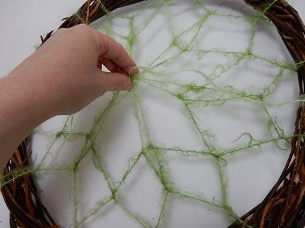 Pull the loops to the middle point of the wreath and secure Pull the loops to the middle point of the wreath and secure