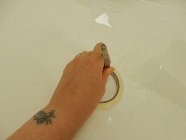 Score a circular outline with a sharp object on to a transparency. Score a circular outline with a sharp object on to a transparency.