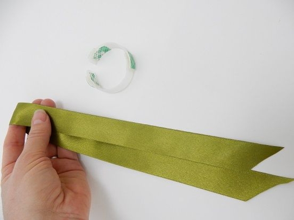 Fold the ribbon in half to get the middle point Fold the ribbon in half to get the middle point