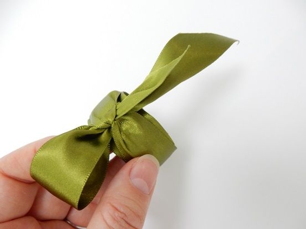 Tie the ribbon ends in a decorative knot or bow Tie the ribbon ends in a decorative knot or bow