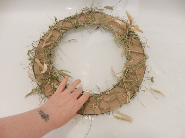 To remove the cardboard soak the wreath in a water bath