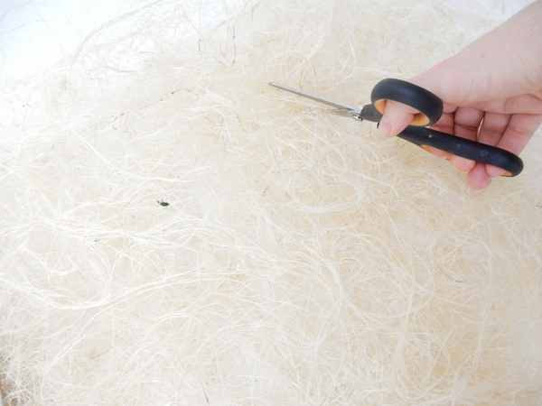 Cut a disk shape in the sisal to create a frame for the focal point Cut a disk shape in the sisal to create a frame for the focal point