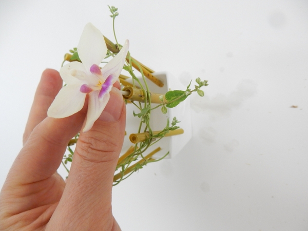 Fit the flower stem into the water filled cavity