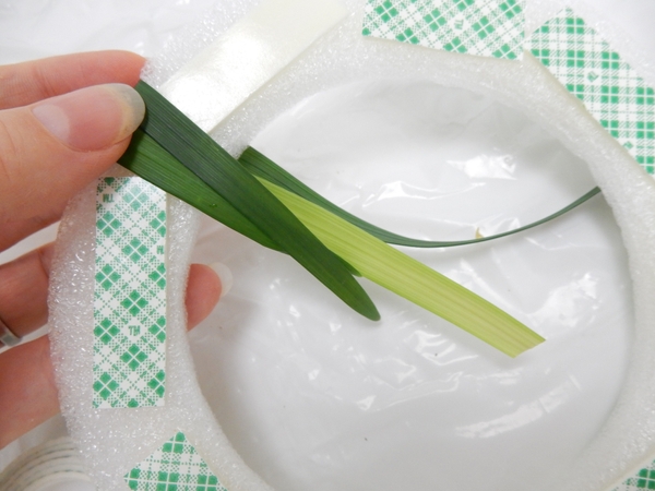 Place the next blade of grass to slightly overlap the first blade Place the next blade of grass to slightly overlap the first blade
