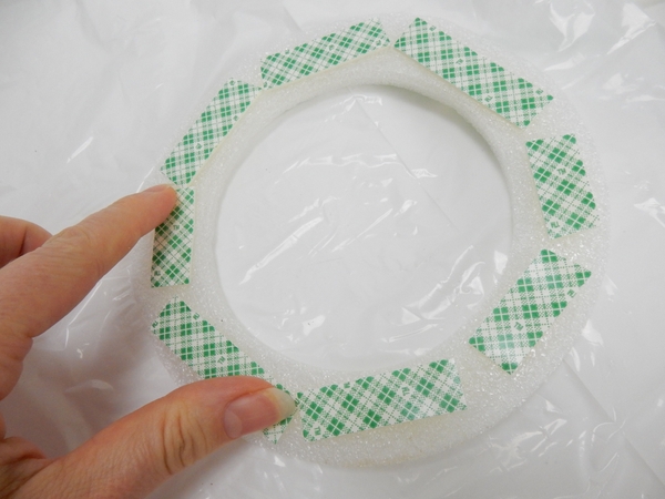 Smooth the tape down all around the disk Smooth the tape down all around the disk