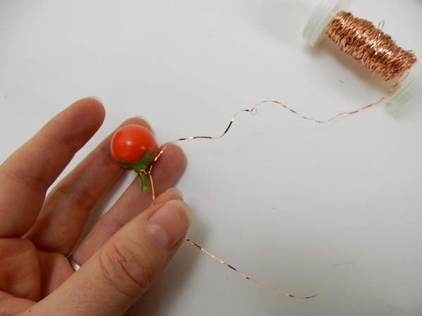 Wrap the wire three times around the stem and twist it twice to secure