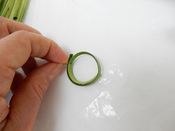 Curve the blade of grass into a ring and secure with decorative wire Curve the blade of grass into a ring and secure with decorative wire