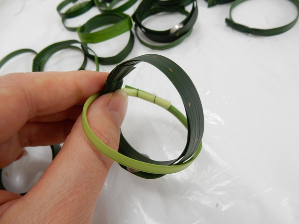 Slip a grass ring over a magnetic grass ring and secure with wire Slip a grass ring over a magnetic grass ring and secure with wire