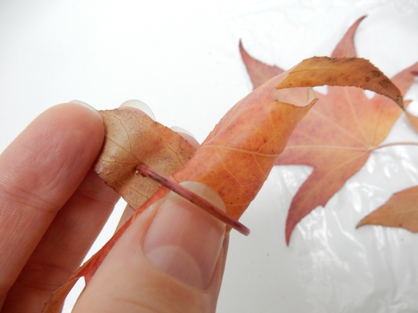 Slip the stem through the hole and carefylly pull it tight to secure the roll