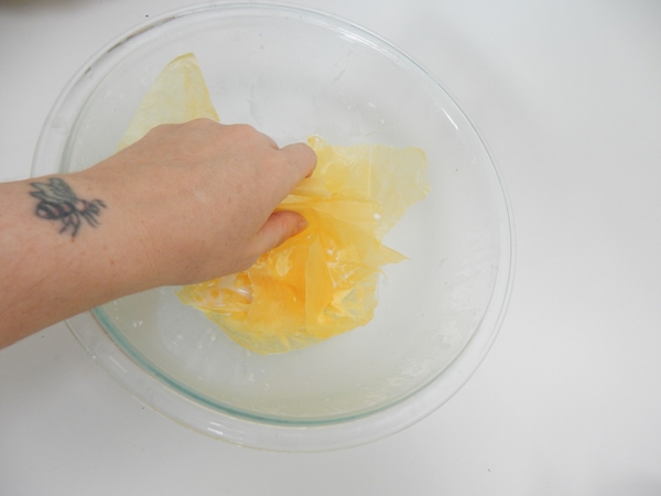 Soak yellow tissue paper in thinned wood glue Soak yellow tissue paper in thinned wood glue