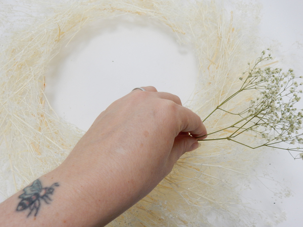Place the wreath on a flat working surface and glue a snippet of dried Gyp to follow the shape