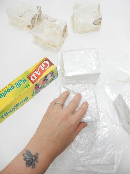 Cover the boxes with new clingfilm but this time bulk it up slightly around the top edge Cover the boxes with new clingfilm but this time bulk it up slightly around the top edge