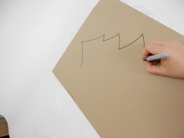 Draw a large Christmas tree shape on cardboard