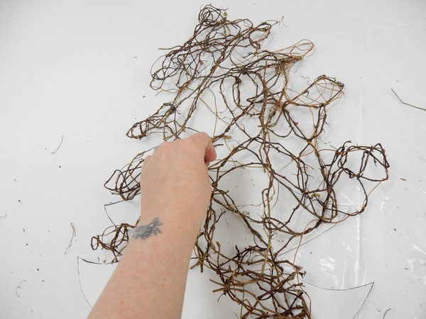 Weave in fresh vine to fill in any gaps to complete the Christmas tree shape Weave in fresh vine to fill in any gaps to complete the Christmas tree shape