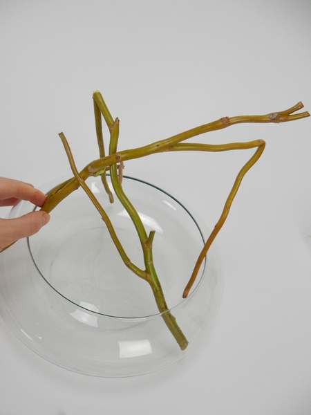 Bend another twig and place it over the first. Bend another twig and place it over the first.