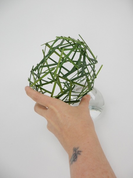 Fill a small glass vase with water and set the grass armature on the vase. Fill a small glass vase with water and set the grass armature on the vase.