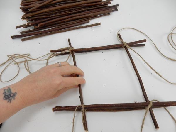 Secure the twig with a knot and add another twig Secure the twig with a knot and add another twig