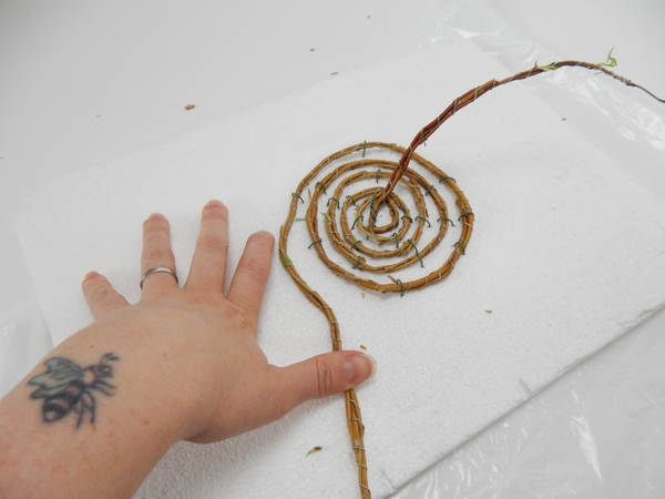 Slowly spiral the garland and pin it into position. Slowly spiral the garland and pin it into position.