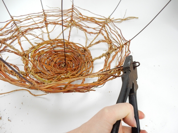 Bend the wire ends in with heavy duty pliers and finish the looser weave right up to the bend Bend the wire ends in with heavy duty pliers and finish the looser weave right up to the bend