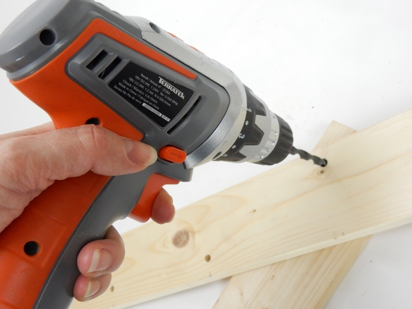 Drill holes in a piece of lumber Drill holes in a piece of lumber