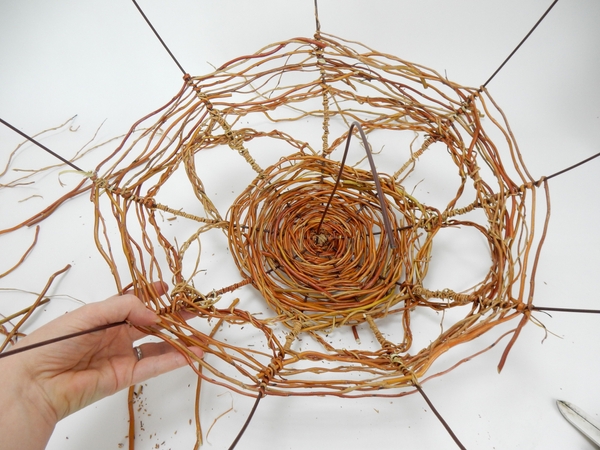 Wrap more thin willow stem around these stems to secure the braided stems Wrap more thin willow stem around these stems to secure the braided stems