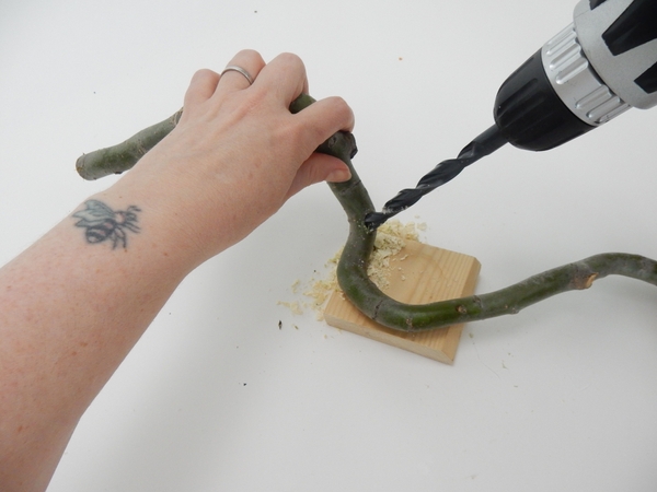 Drill a thicker hole through the twig at the exact angle you want the tube Drill a thicker hole through the twig at the exact angle you want the tube