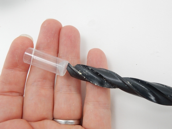 Measure a drill bit against the drinking straw tube Measure a drill bit against the drinking straw tube